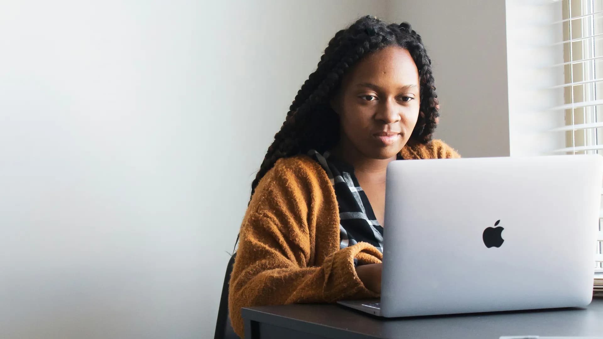 A student researching university options on a laptop